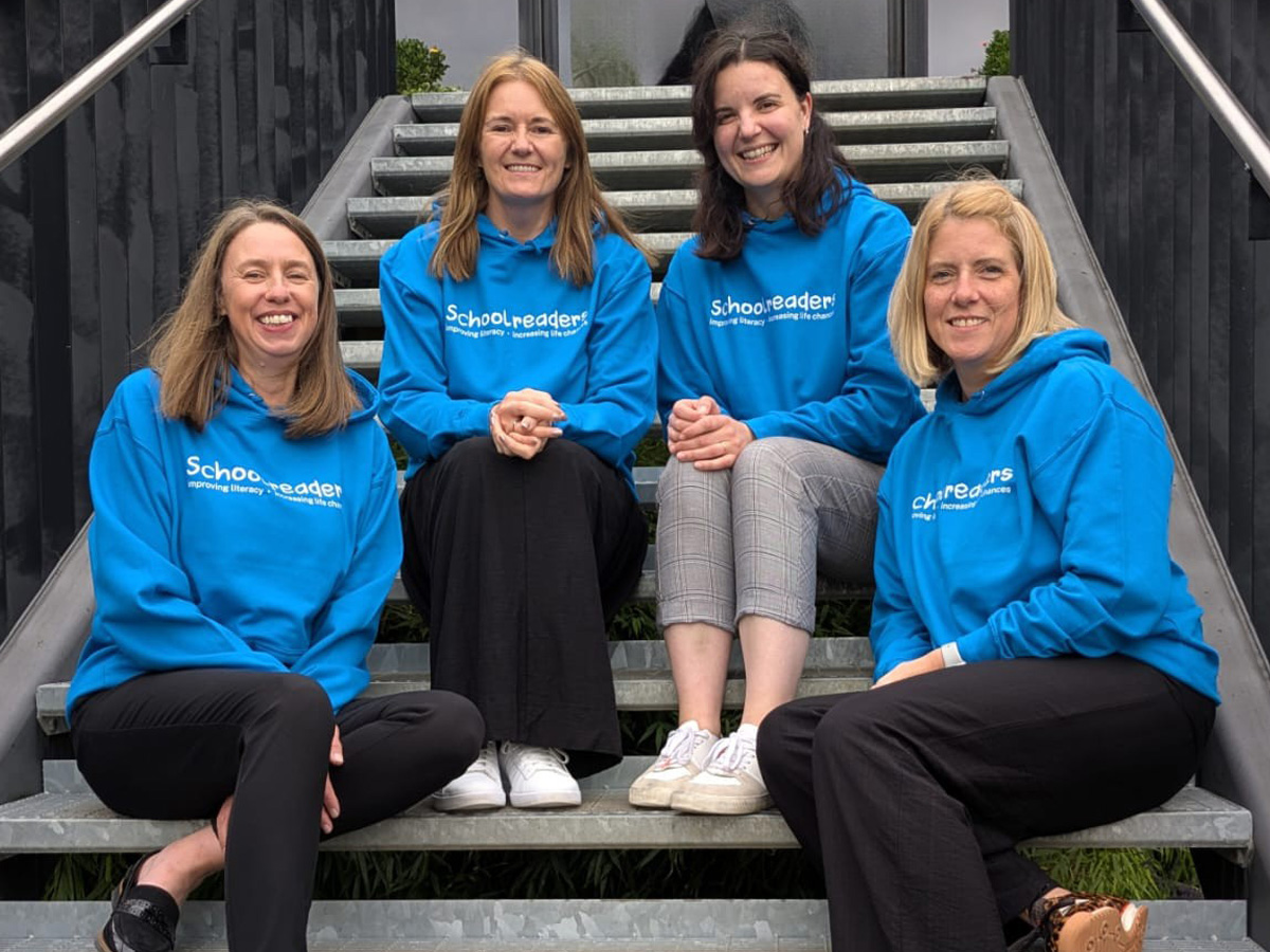 Schoolreaders team wearing printed blue hoodies