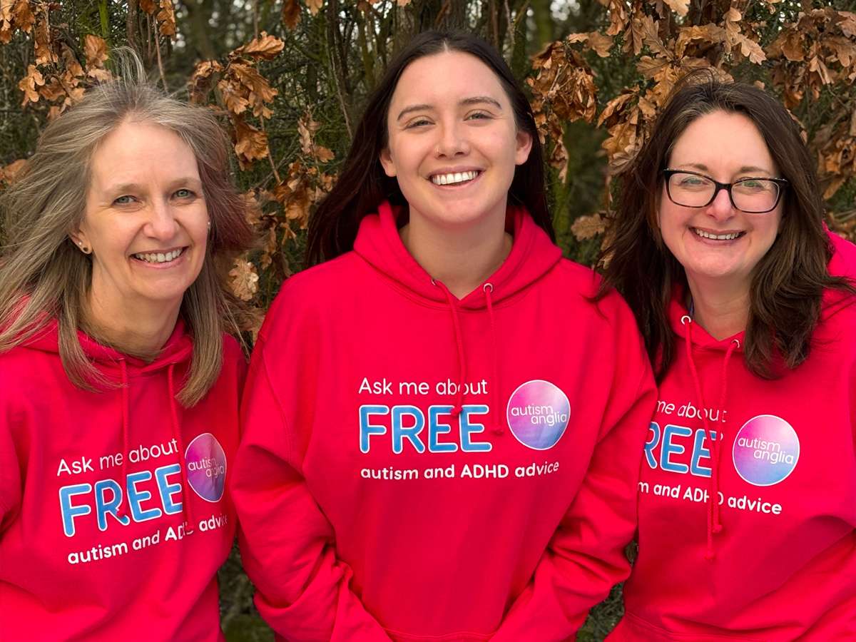 Autism Anglia team wearing printed red hoodies