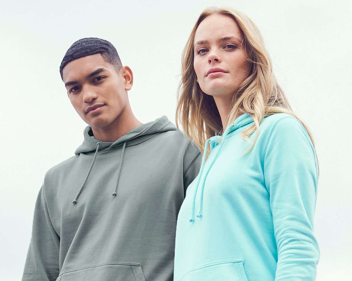 man and woman posing in hoodies