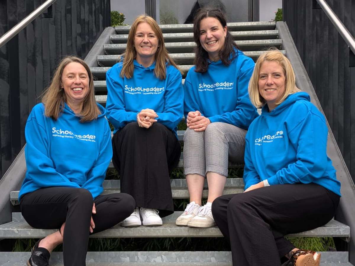 Schoolreaders team wearing printed blue hoodies