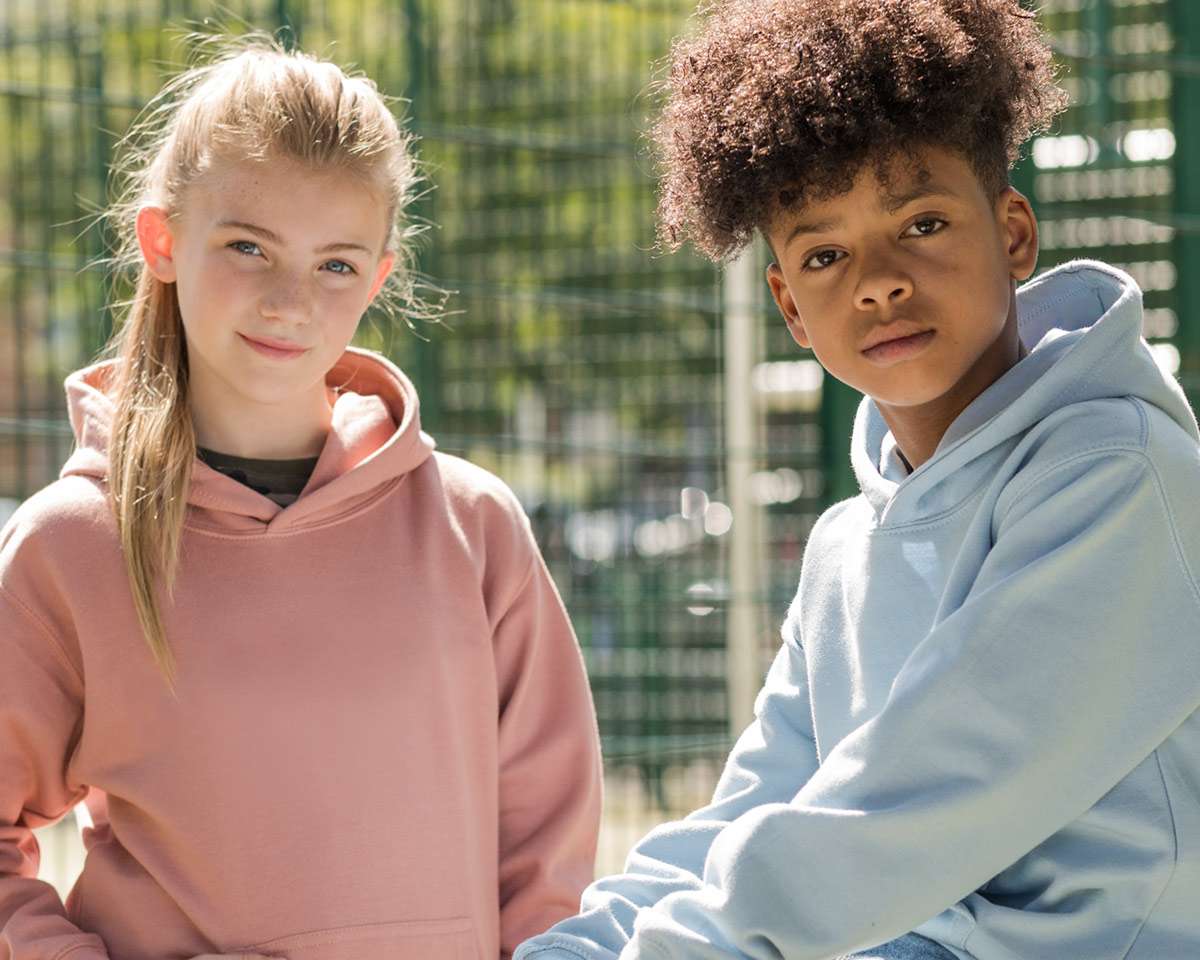 girl and boy posing in hoodies