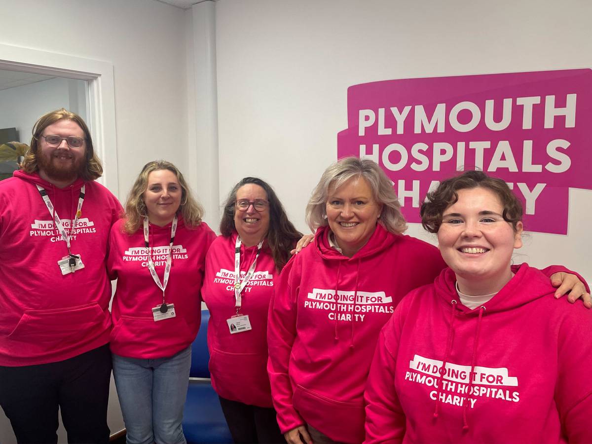 Plymouth Hospitals Charity team wearing printed pink hoodies