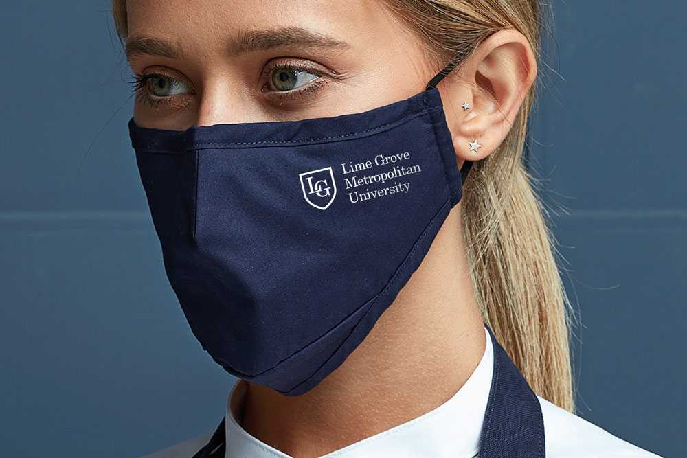 woman in navy blue face mask with university logo printed on the side